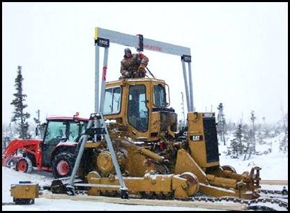 A 3 ton portable aluminum crane and chain hoist being used in in the frozen tundra to remove a CAT cab